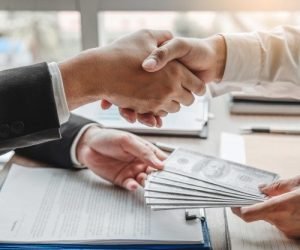 Premium Photo _ Businessman shaking hands giving dollar bills corruption bribery to business manager to deal contract